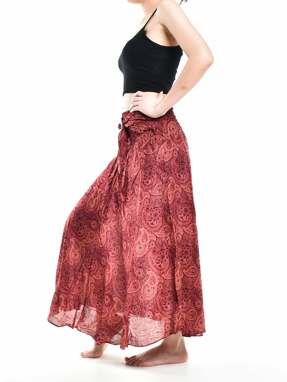 Bohotusk Red Orbit Long Skirt featuring a coconut buckle, showcasing its flowing design and elasticated smocked waist.